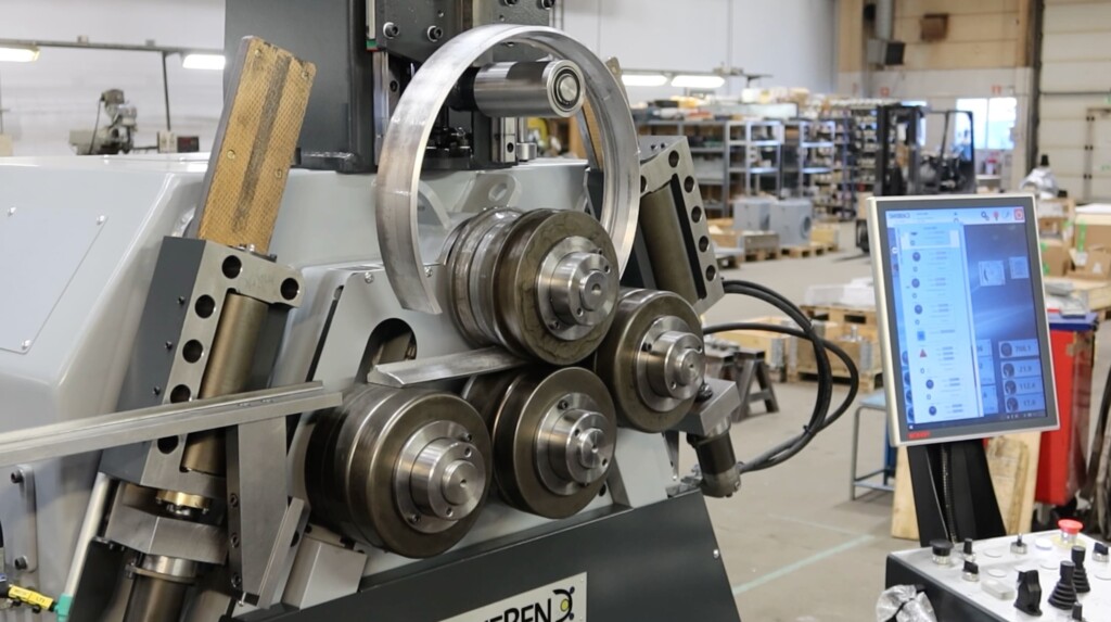 Extruded aluminium profiles being bent into shroud rings using custom rolls on the SweBend SB4 65S section bending machine.