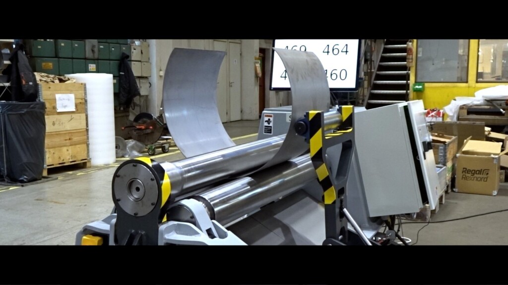 SweBend PB3-6-4 – Superduplex Cone Bending SweBend PB3-6-4 three-roll plate bending machine forming a Superduplex stainless steel cone with side support visible and digital display showing roll positions