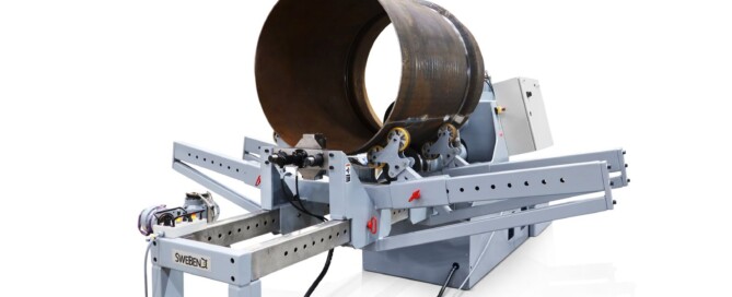 Full view of the SweBend JM-140 joggling machine with control cabinet, drive end, and outboard support rail