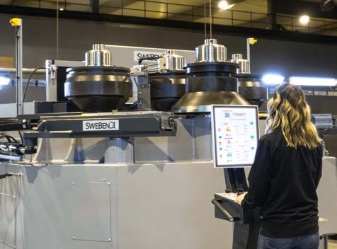 Operator using the SEVEN CNC touchscreen at a section bending machine